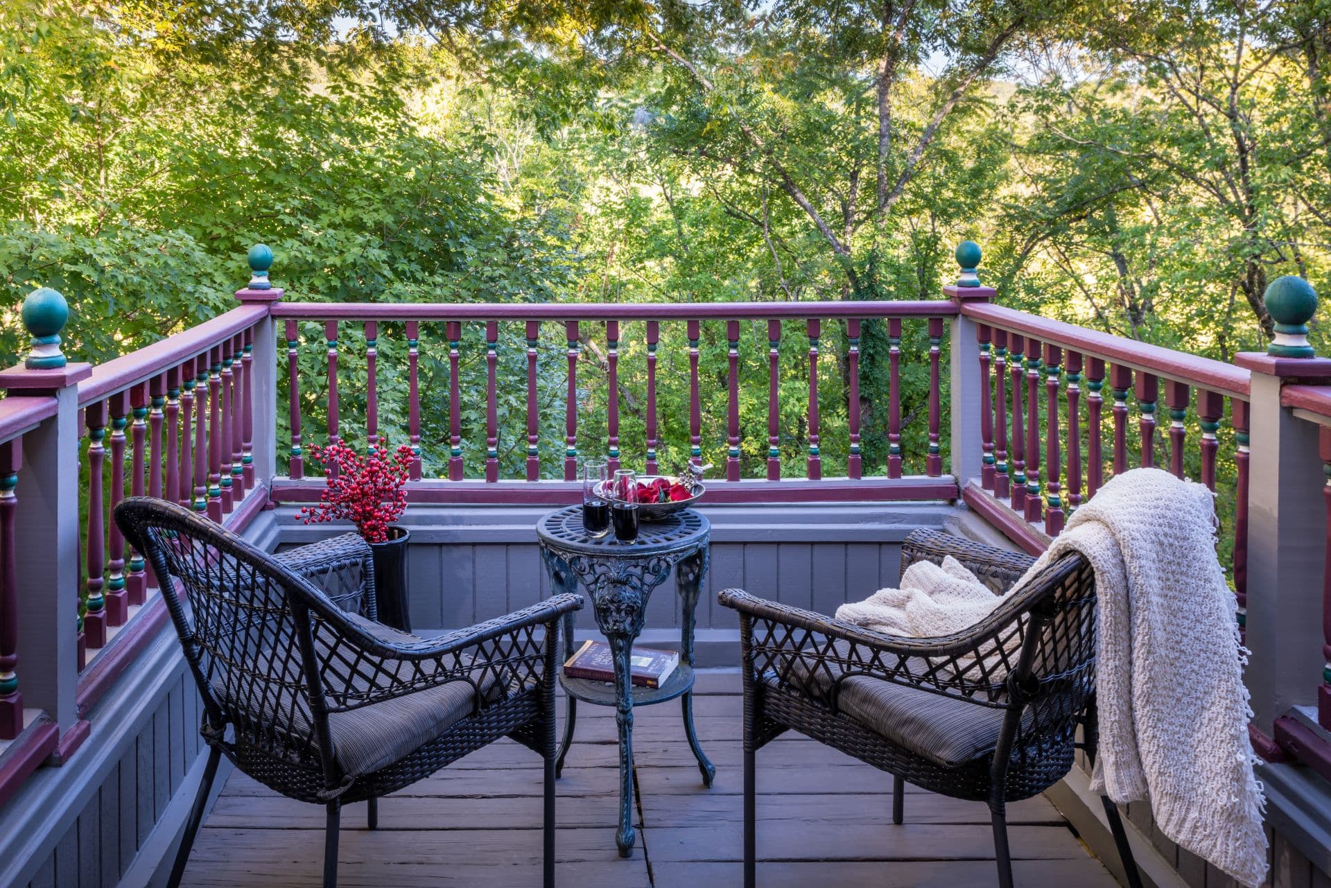 Private balcony with two chairs and small table overlooking East Mountain.